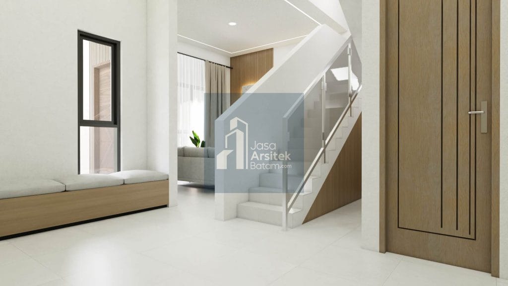 Desain interior ruang tengah dengan tangga minimalis, kursi panjang, dan pencahayaan alami yang membuat ruang terasa luas dan nyaman.